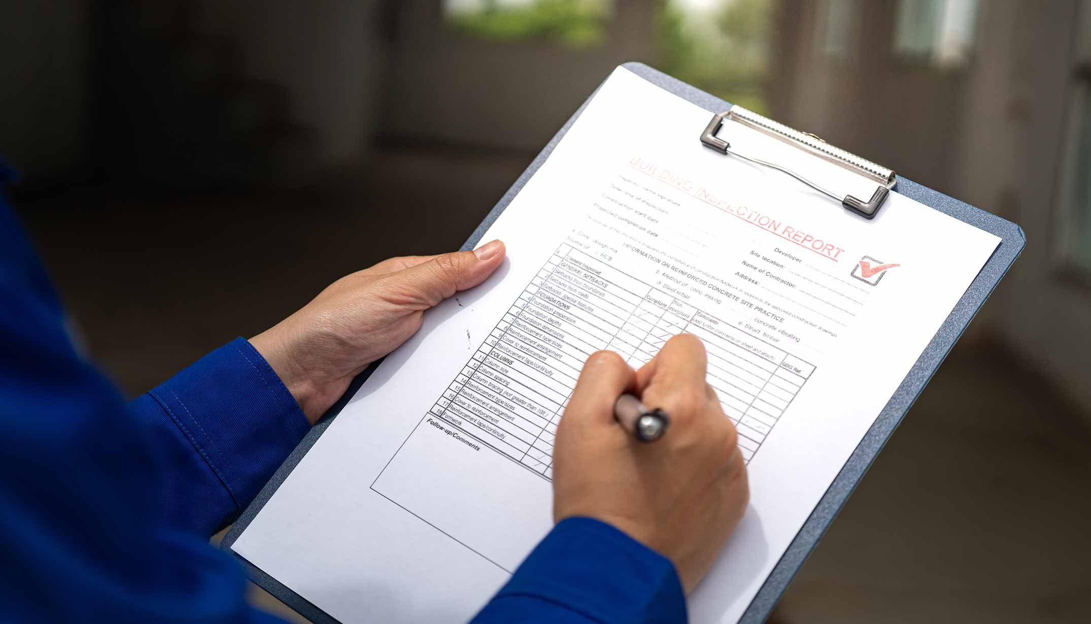 Builder with clipboard and final walkthrough inspection checklist