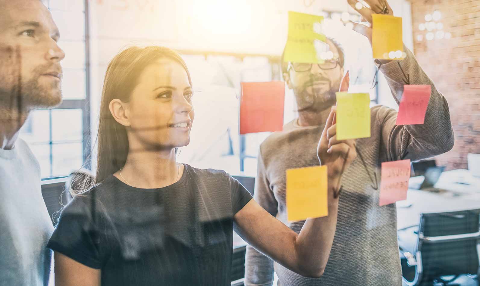 3 people in conference room with sticky notes journey mapping for a home builder