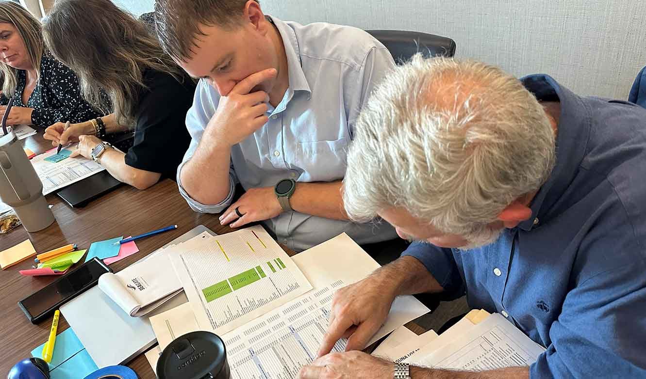Interviewing-home-builders-sitting-at-table-and-reviewing-documents2