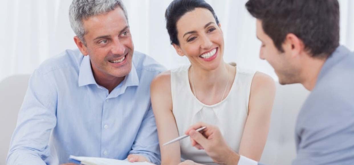 Middle aged couple meeting with an online sales consultant to buy a new home