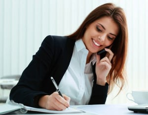 Smiling Female Online Sales Consultant talking on the phone