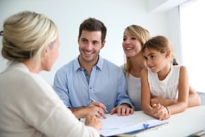 Young family talking with a home builder agent about their dream home