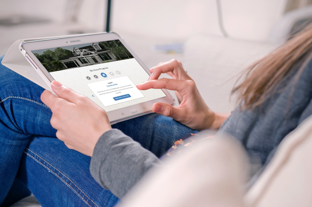 Woman looking at home building timeline on her ipad