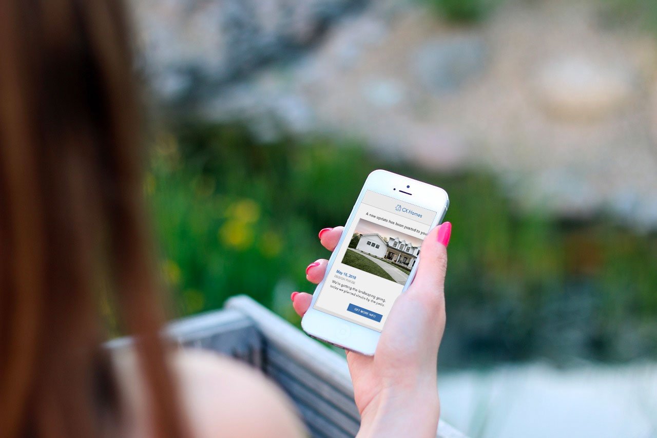 Woman-looking-at-construction-update-on-her-iphone