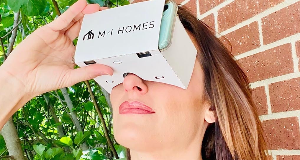 Woman-using-VR-with-phone-to-view-MI-home