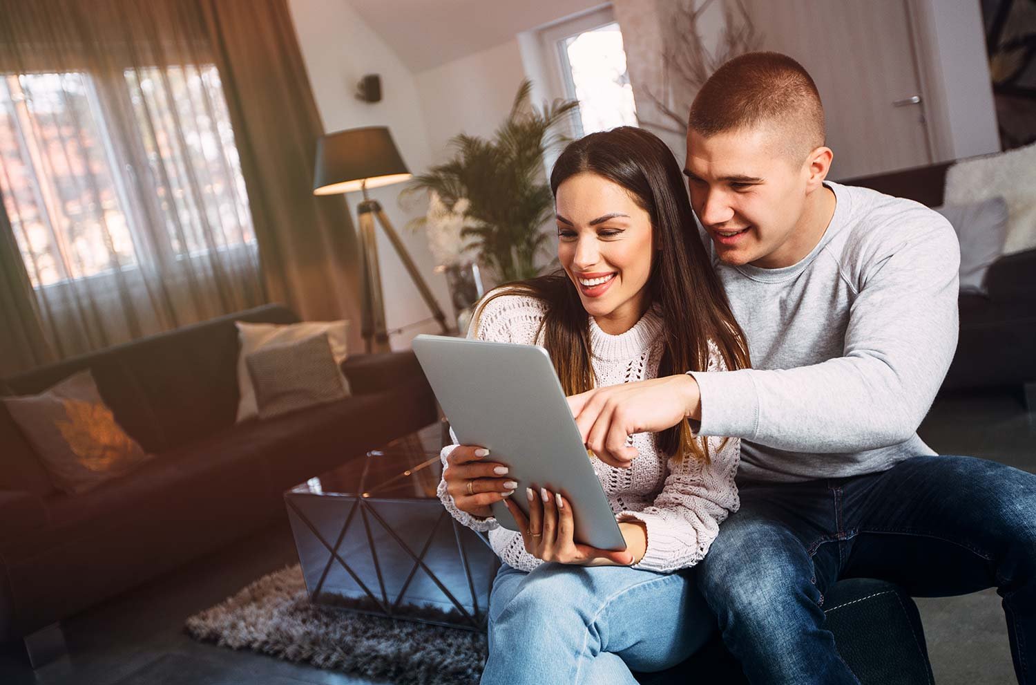 Young-couple-shopping-for-new-home-on-an-ipad