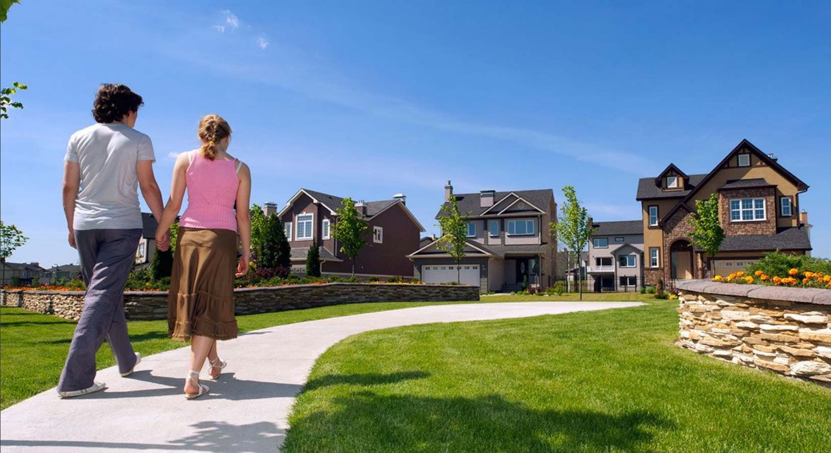 Young couple walking toward community selling new homes