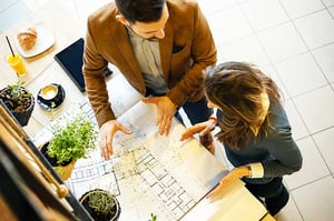 architect and salesperson reviewing new home floor plan