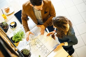 architect and salesperson reviewing new home floor plan