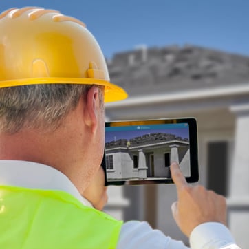 Building supervisor taking a progress-tracking photo of a home under construction