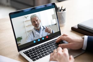 Computer screen showing doctor on webcam