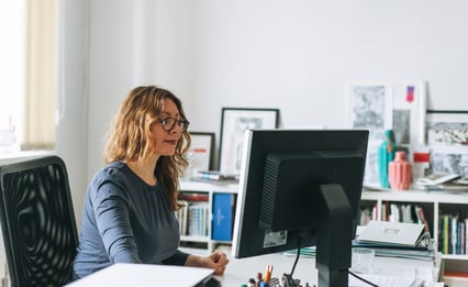 woman-in-chair-at-desk-working