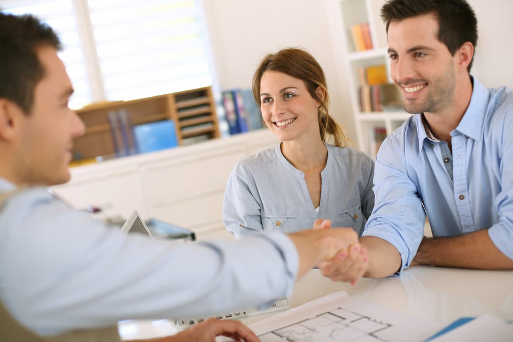 Young couple meeting home builder - customer experience